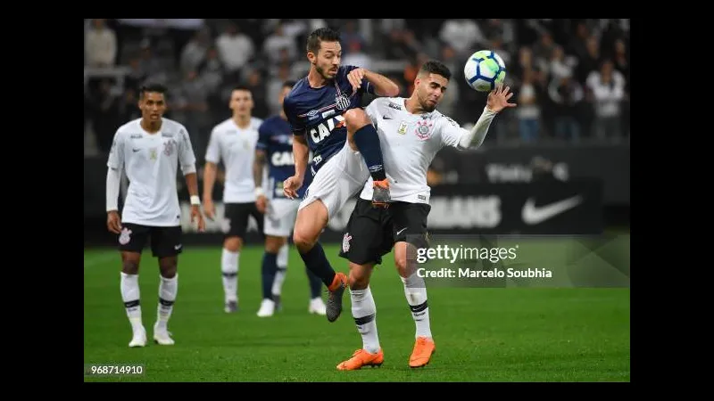 Cầu thủ Santos điều khiển bóng qua hậu vệ Corinthians trong trận đấu